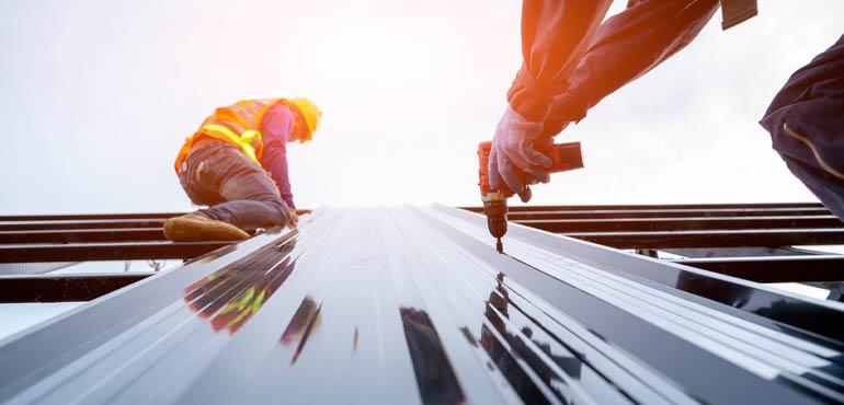 Roofers drilling roofing