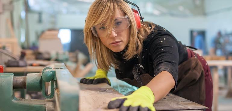 banner-licence-40-female-cabinet-maker-checking-timber