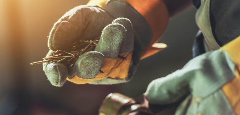 banner-property-12-gloves-holding-long-screws