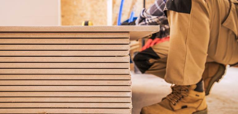 Builder inspecting MDF board