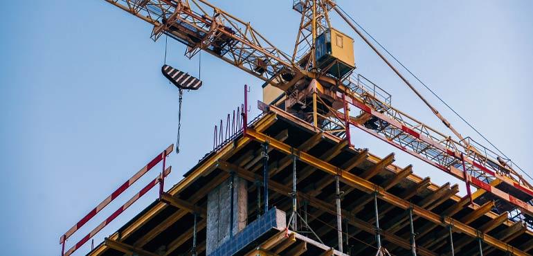 banner-trust-12-crane-atop-corner-building
