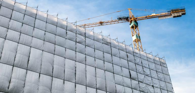 banner-trust-7-wrapped-building-white-crane