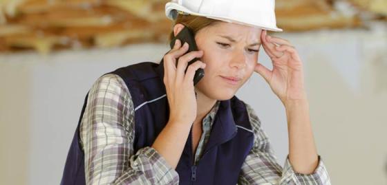 banner-compliance-3-woman-phone-worried-white-hardhat