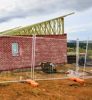 Incomplete house behind fencing